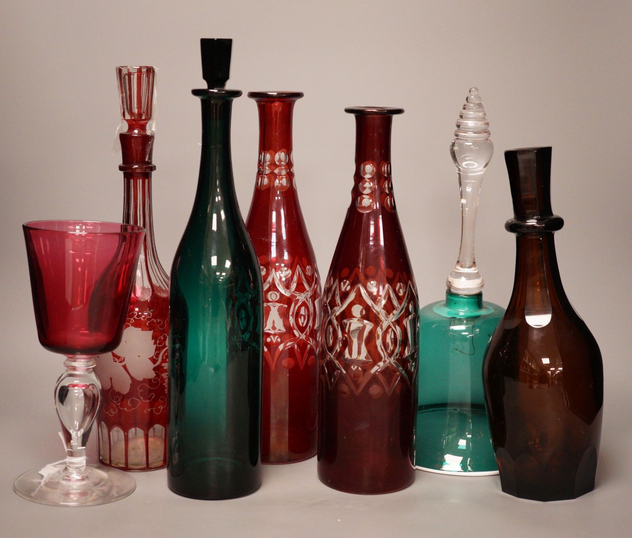 A pair of cut ruby flashed glass decanters, late Georgian emerald green glass decanter, and four other items